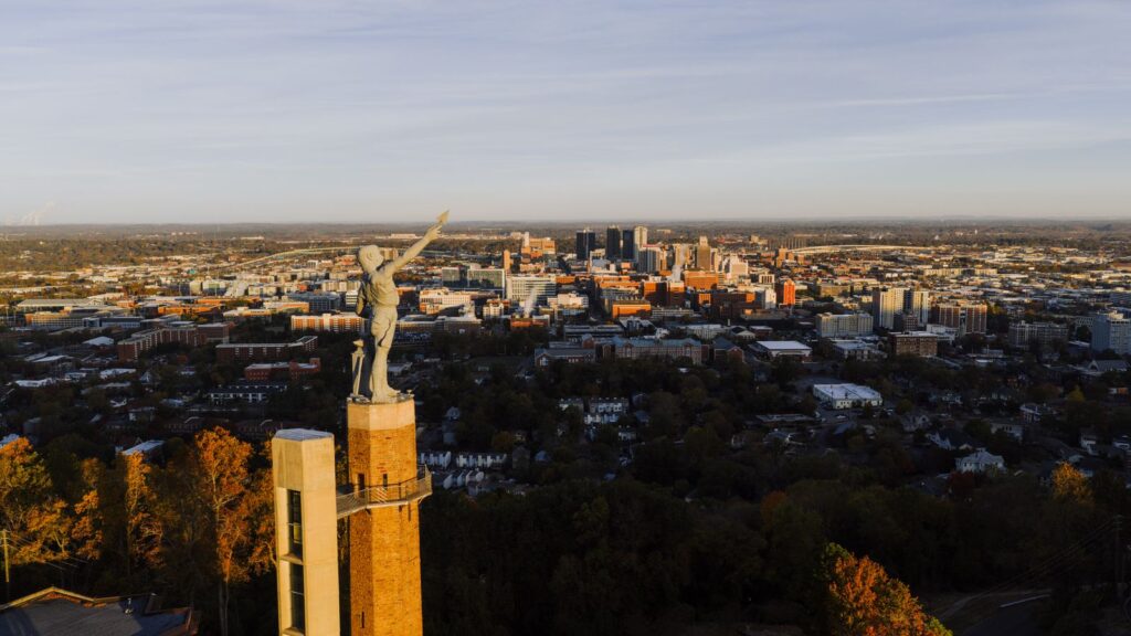 Drone capture of the Vulcan statue with Birmingham city skyline at sunset, Alabama