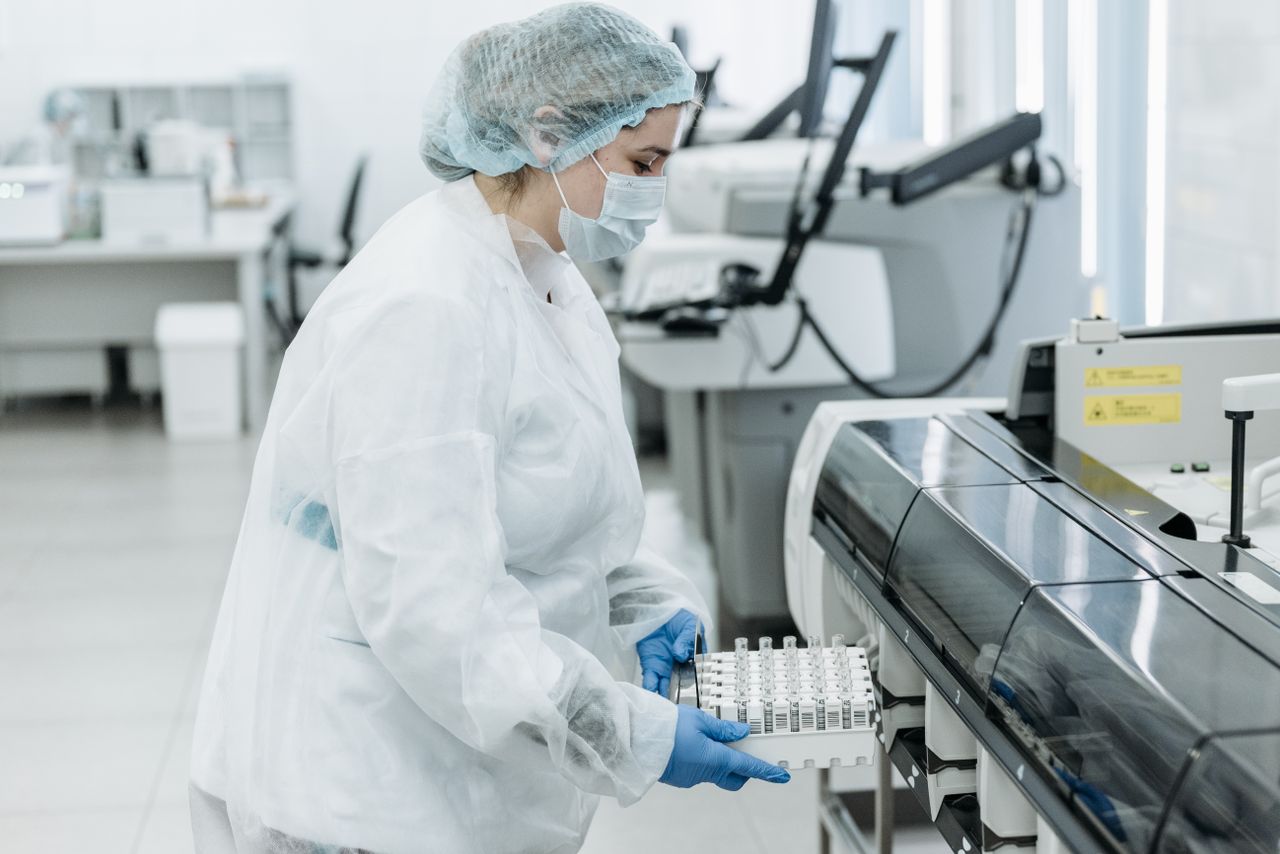 Laboratory scientist in protective gear working with samples