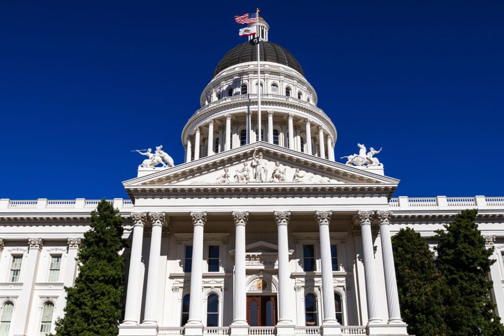 Sunlit view of the California State Capitol with clear blue skies