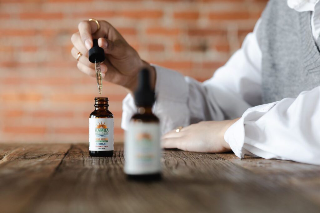 CBD oil dropper and bottle on a wooden table