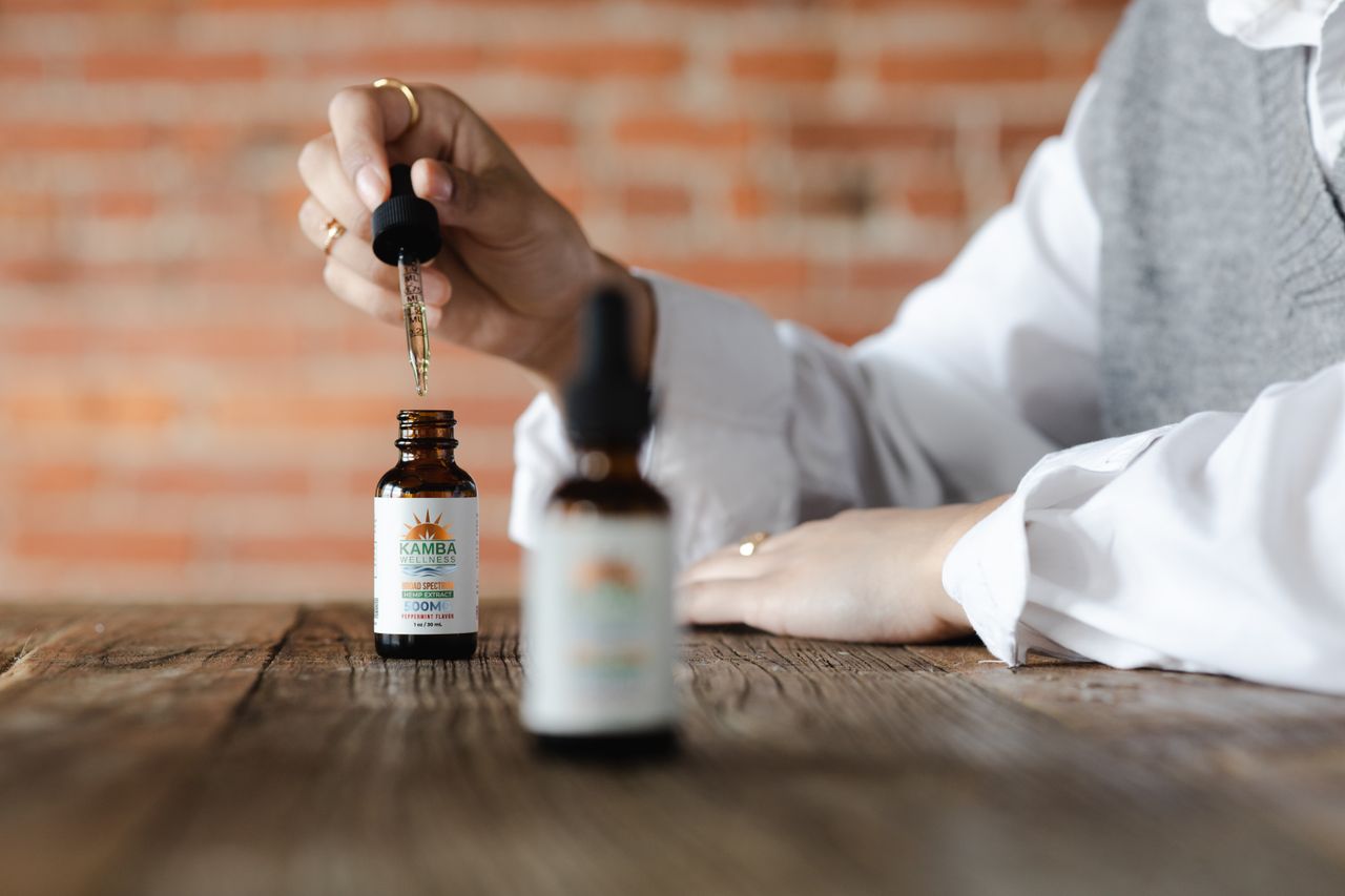 CBD oil dropper and bottle on a wooden table