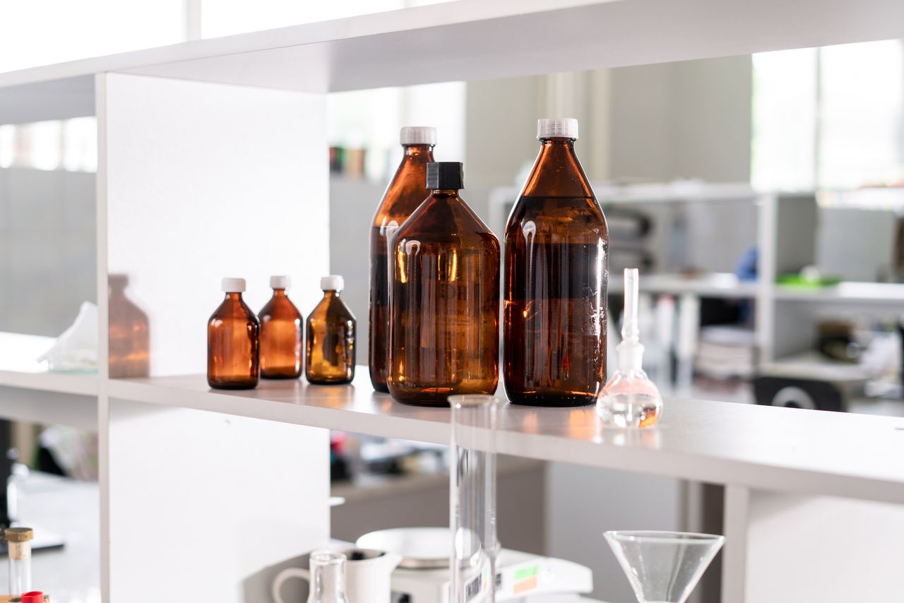 Brown glass bottles on a laboratory shelf