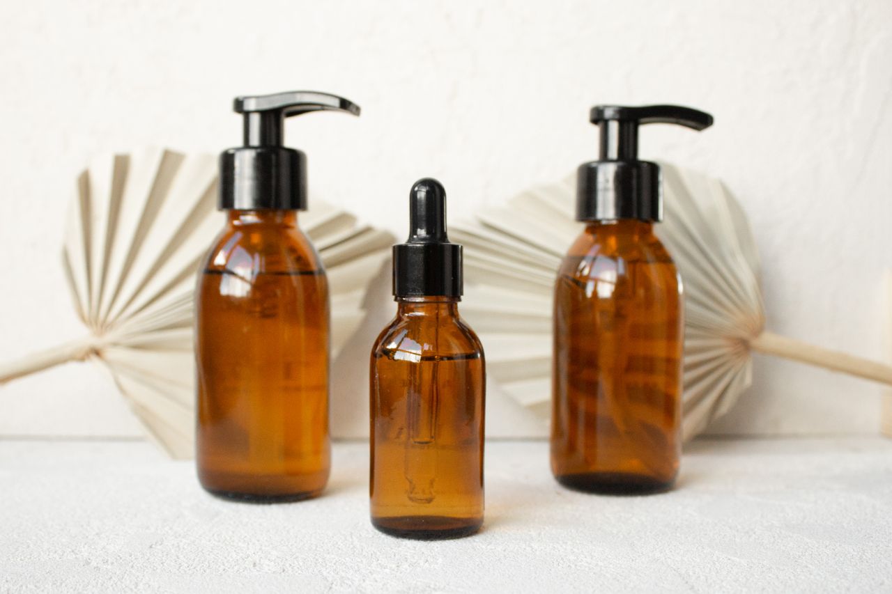 Three amber glass bottles with black caps