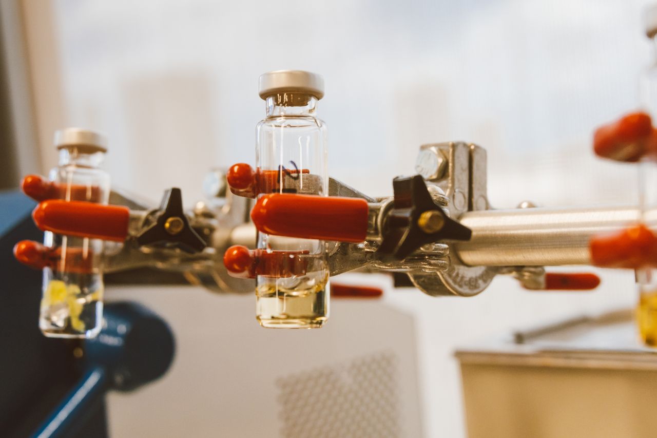 Glass laboratory vials held by a clamp