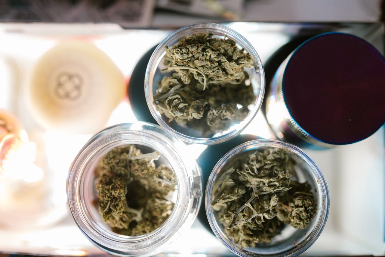 Cannabis buds in glass jars seen from above