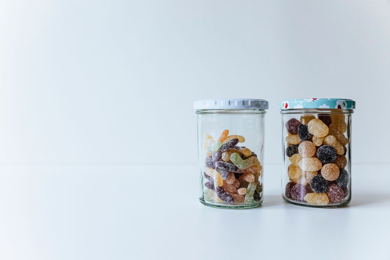 Gummies and sugared candies in glass jars