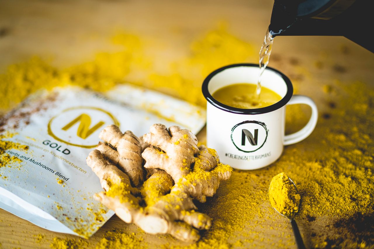Hot water poured into a mug with a mushroom drink blend