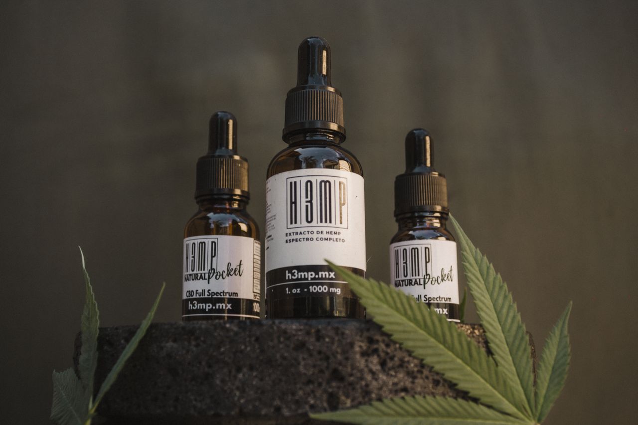 CBD oil bottles with hemp leaves