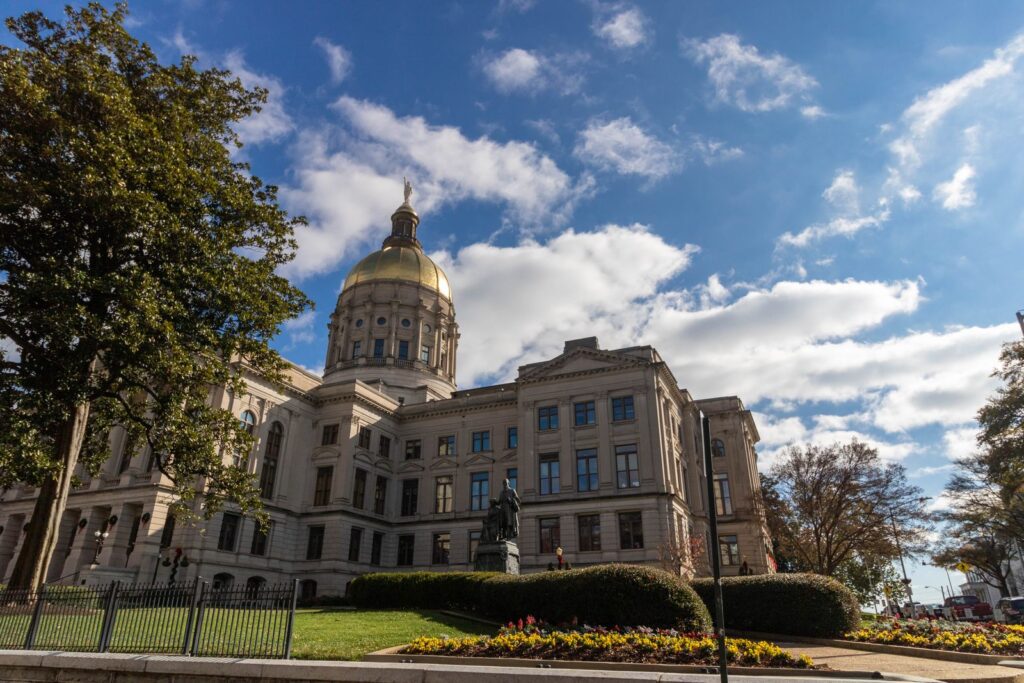 Historic Georgia State Capitol building under a bright blue sky in Atlanta