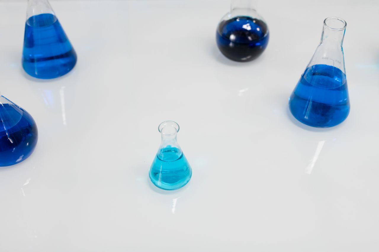 Glass flasks filled with blue liquid