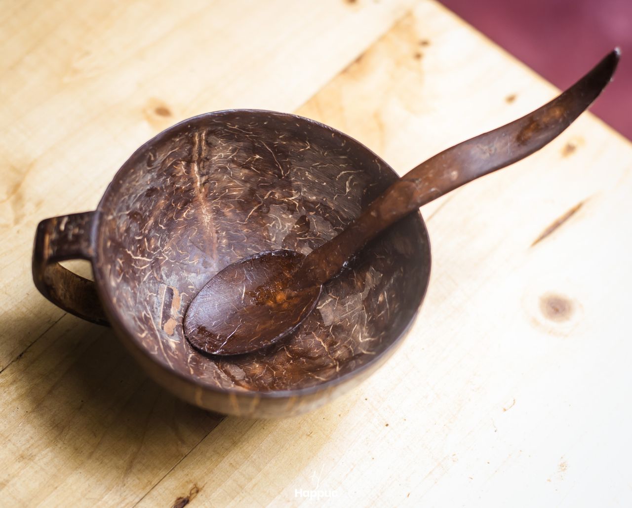 Rustic coconut shell bowl with a matching spoon