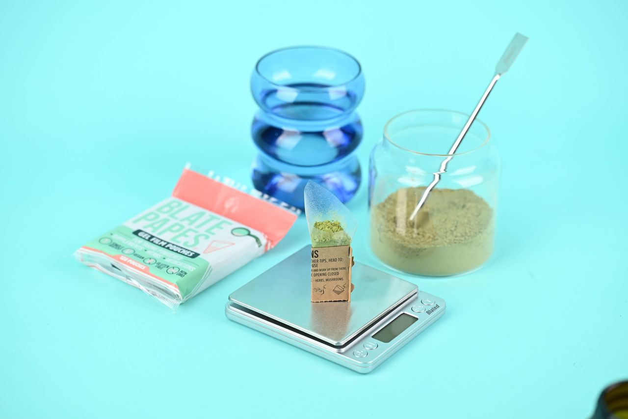 Herbal supplement jar beside a digital scale