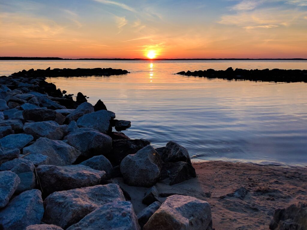 Gorgeous view of a sunset over rocky shorelines in Ocean City, MD, USA