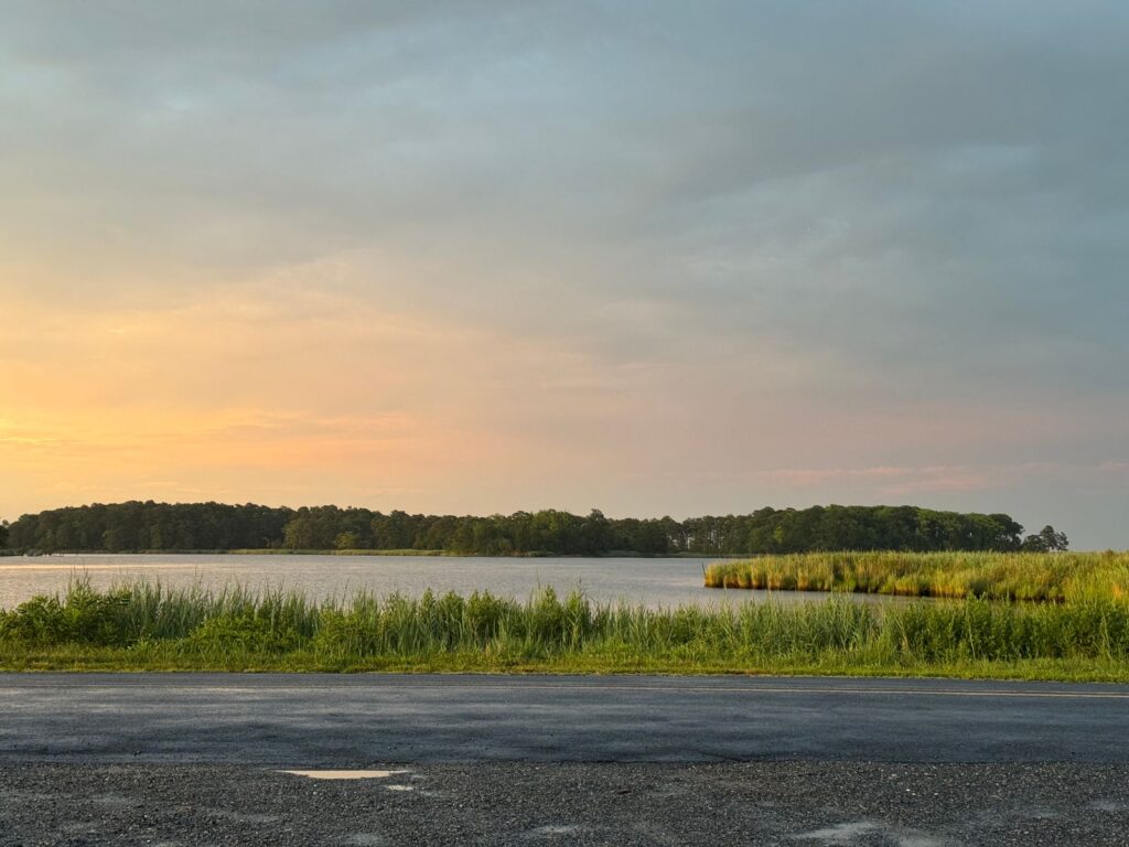 Explore the serene beauty of a sunset over a peaceful waterway in Rock Hall,