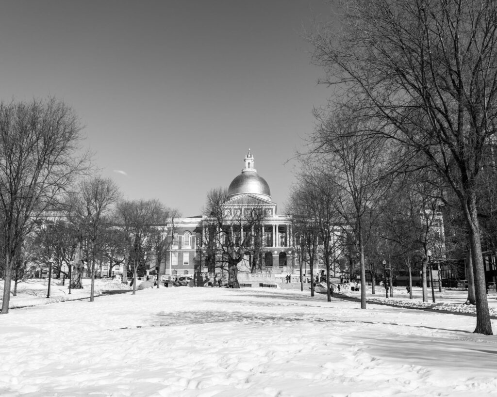 Black and white photo of the Massachusetts State House during winter in Boston