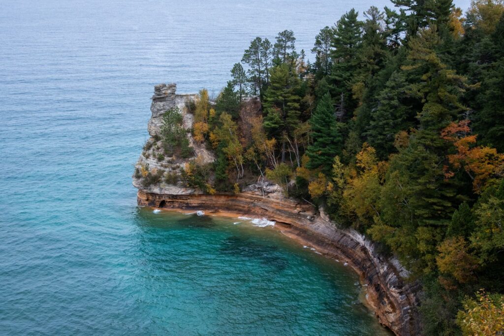 A stunning autumn view of Pictured Rocks in Munising, Michigan, with vibrant