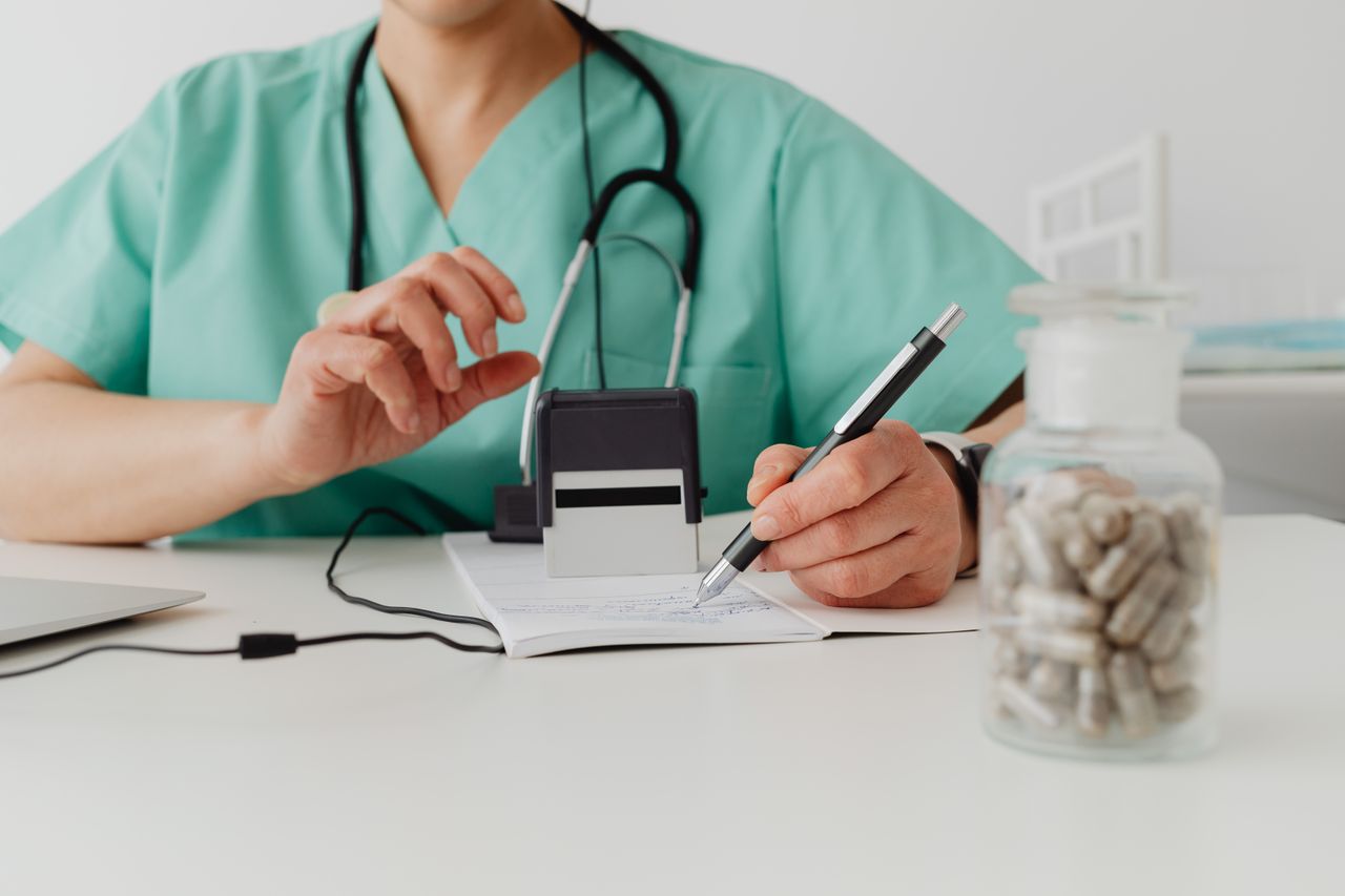 Medical professional writing a prescription