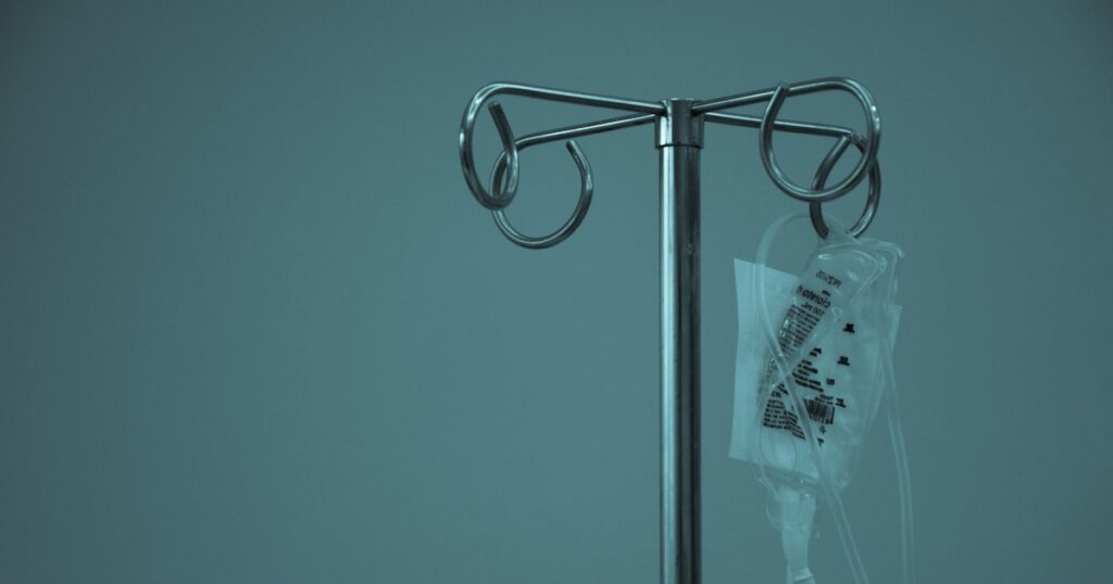 IV bag hanging from a stainless steel drip stand