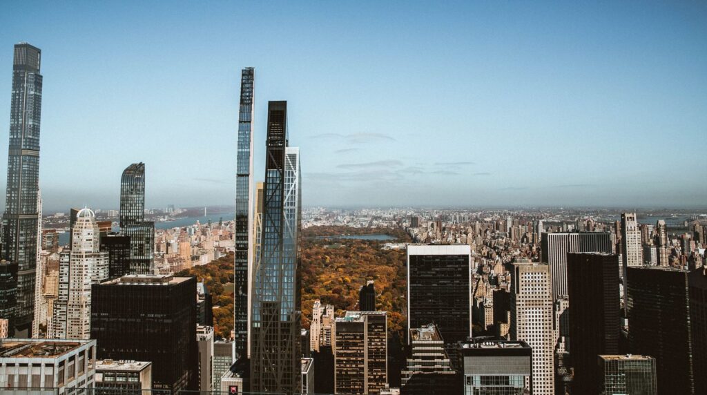 High-rise view overlooking Central Park and New York skyscrapers under a clear blue