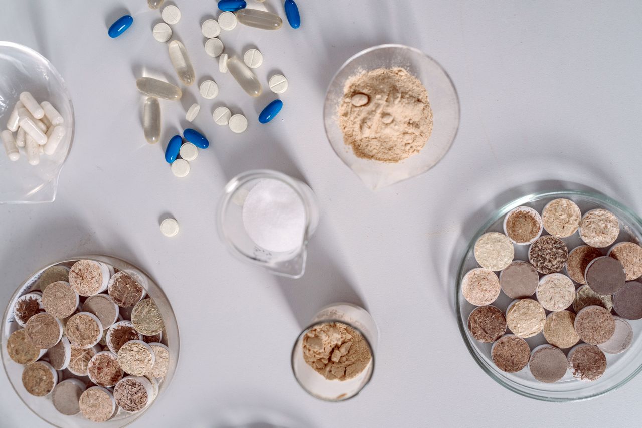 Pharmaceutical ingredients and pills on a white surface