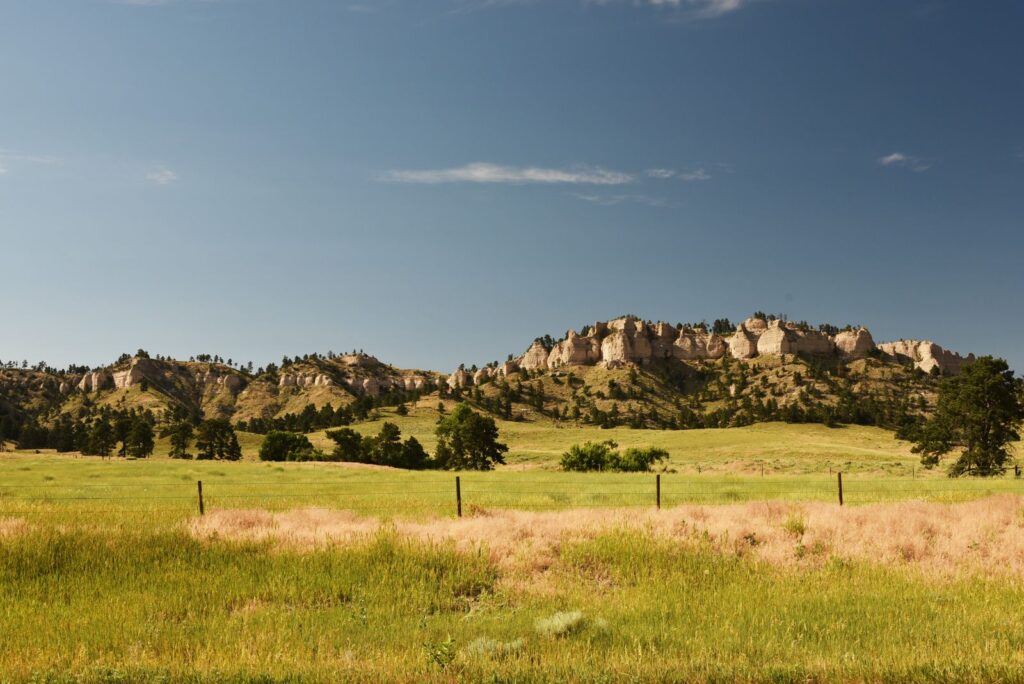 Explore the vibrant, rolling grasslands of North Dakota's Badlands under a clear