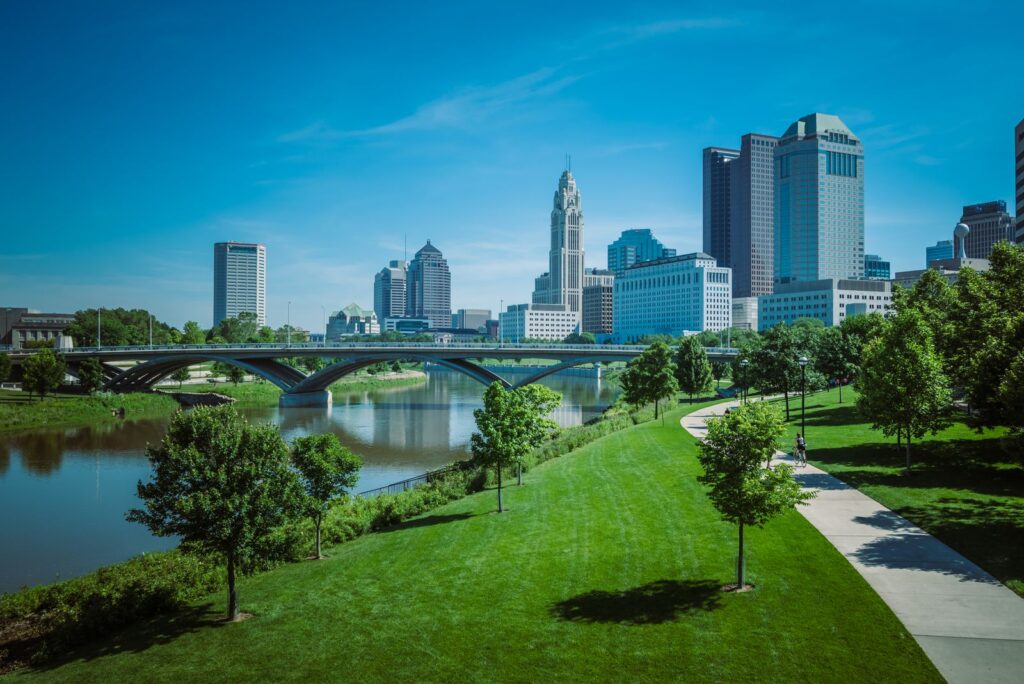 View of Columbus skyline with modern skyscrapers and green park along the river