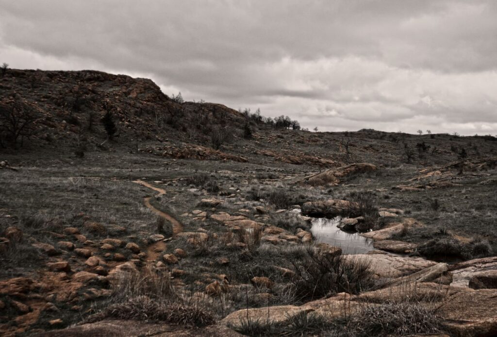 Moody view of rocky terrain and cloudy sky in Wichita Mountains, OK