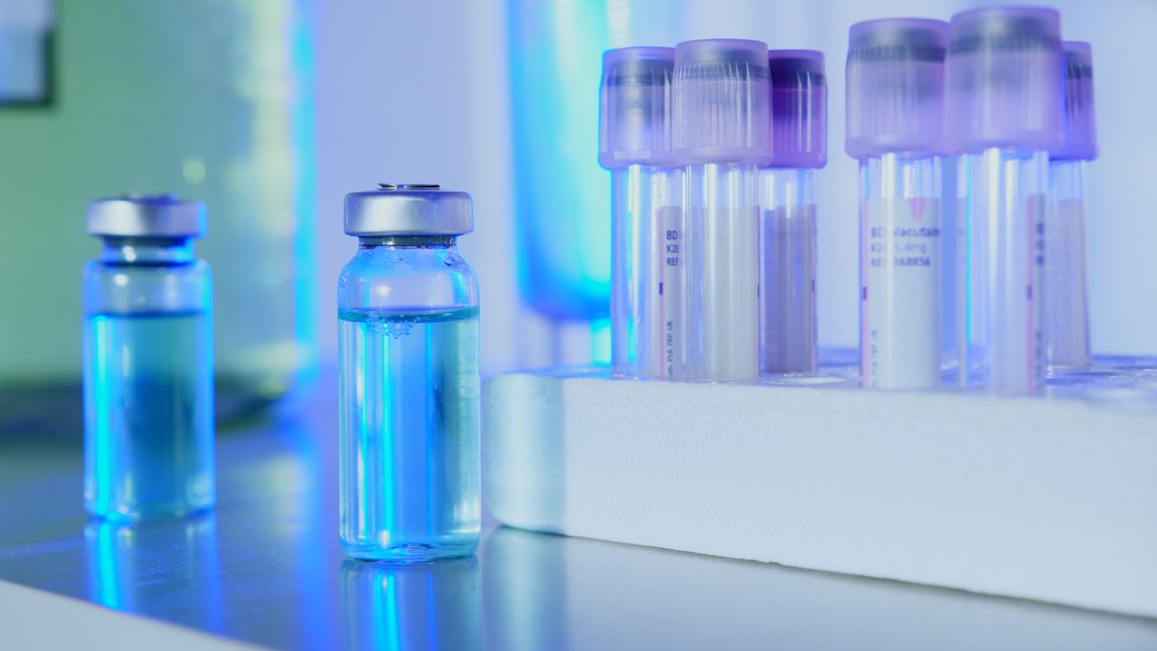 Vials and test tubes with blue liquid in a laboratory
