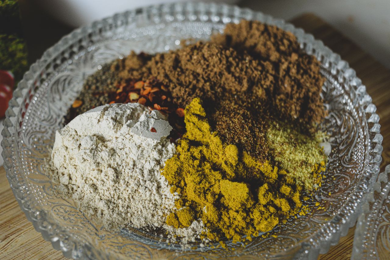 Spices and powders in a decorative glass bowl