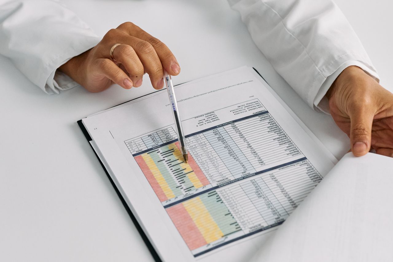 Doctor's hands pointing at medical charts