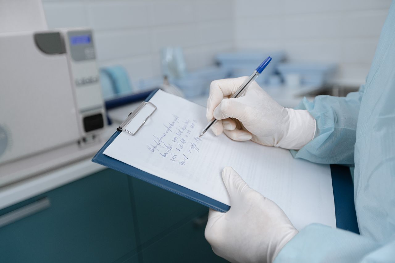 Medical worker in a lab coat writing notes