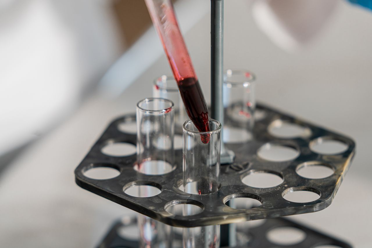 Red liquid being transferred into test tubes