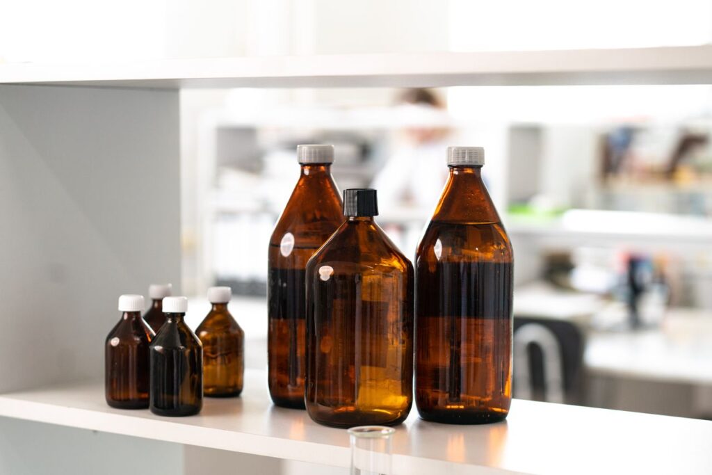 Brown glass bottles on a laboratory shelf