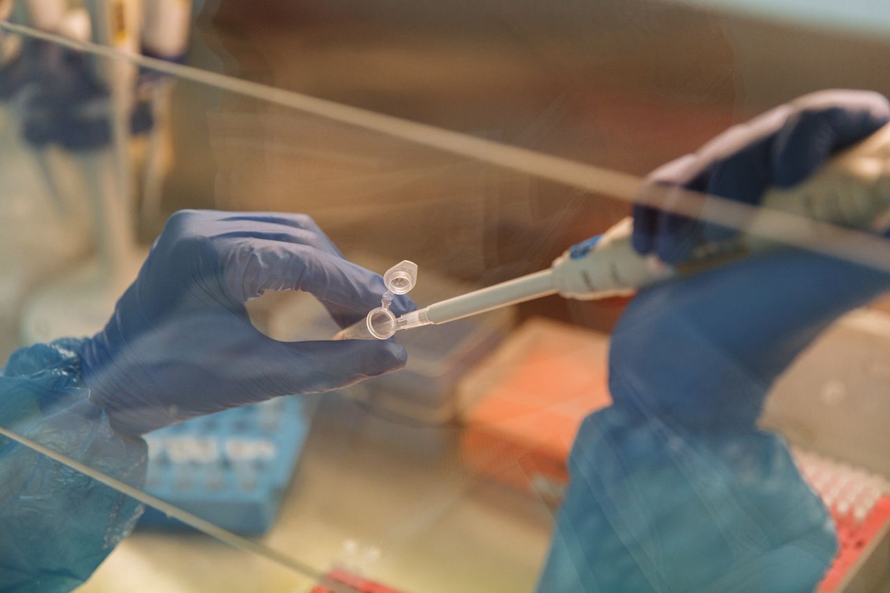 Scientist using a pipette with test tubes