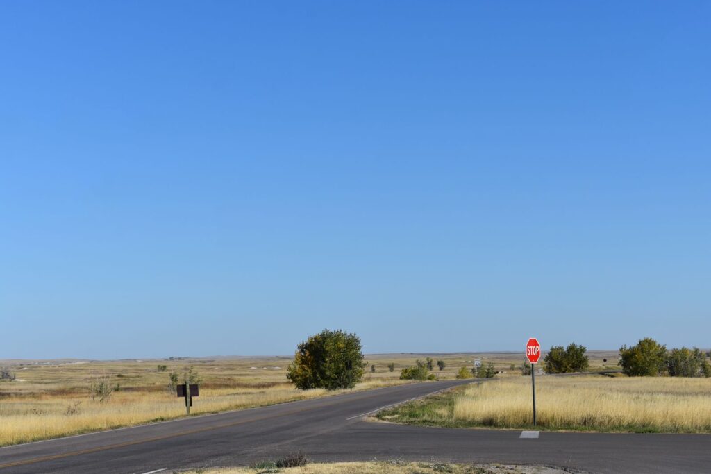 Quiet rural road intersection with a stop sign in South Dakota's open plains