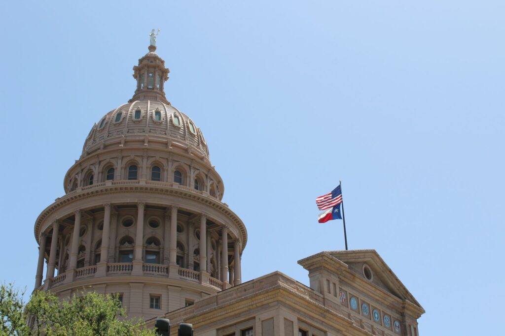 Low angle view of the Texas State Capitol dome and flags in Austin, Texas