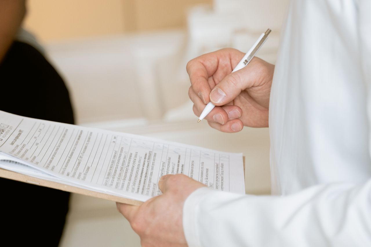 Medical professional examining a clipboard