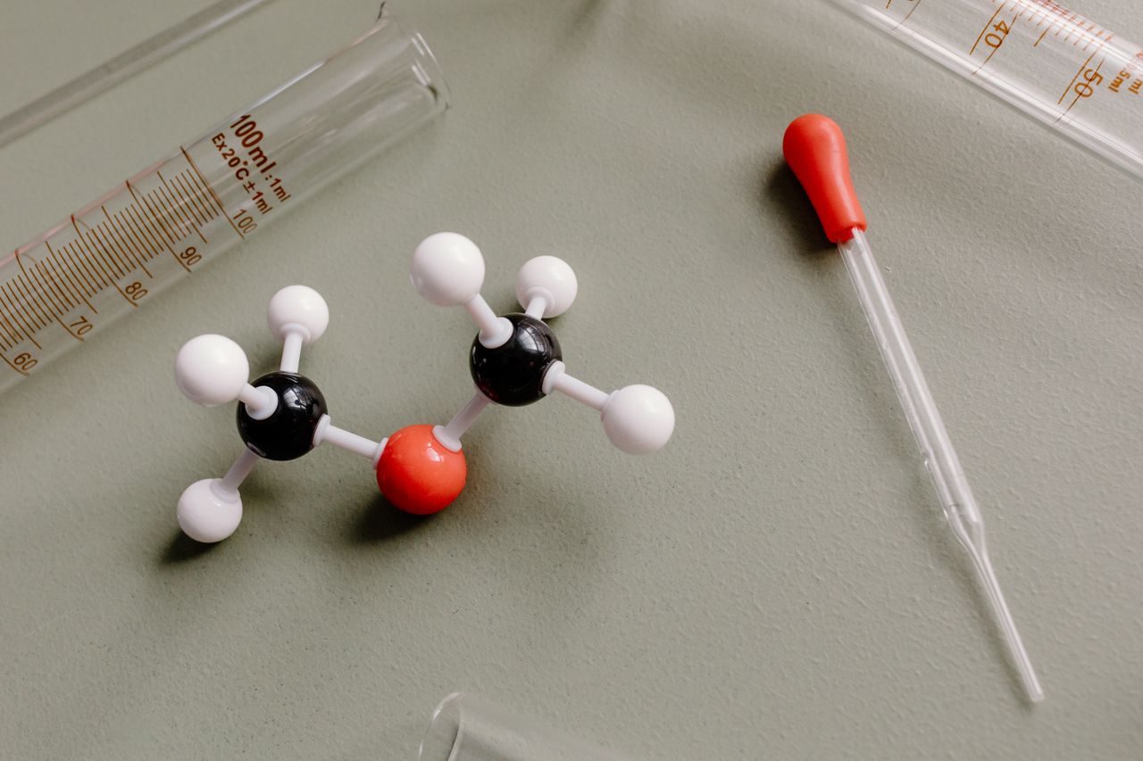 Laboratory equipment beside a molecular model