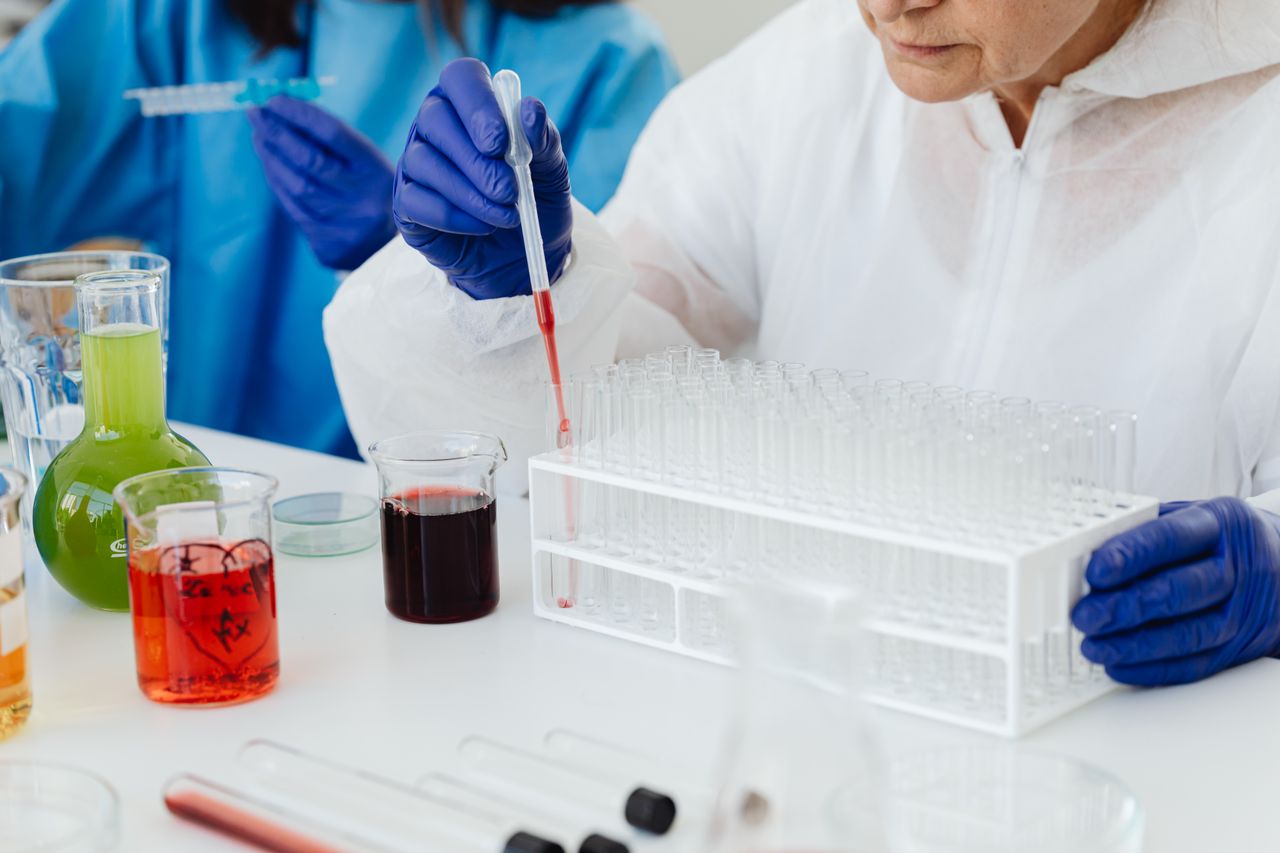 Scientist using a pipette on test tubes