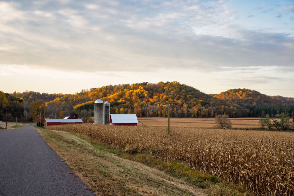 Picturesque view of a farm with silos and fall foliage in Ella, Wisconsin
